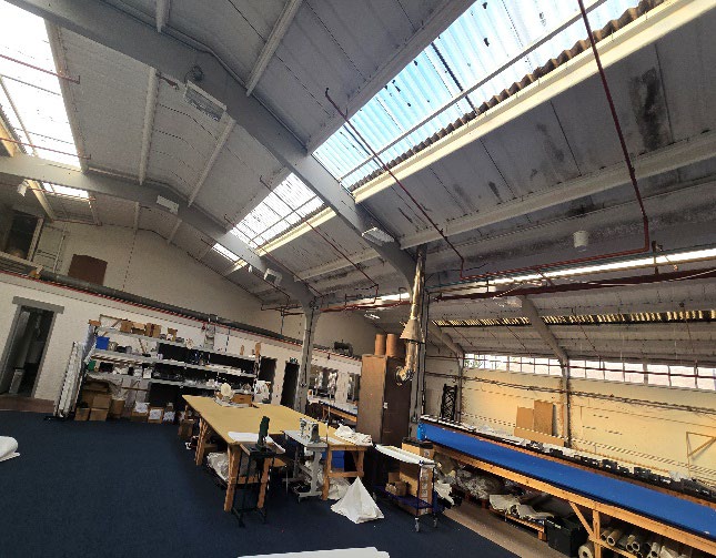 Roof-lit industrial interior with steel portal frame